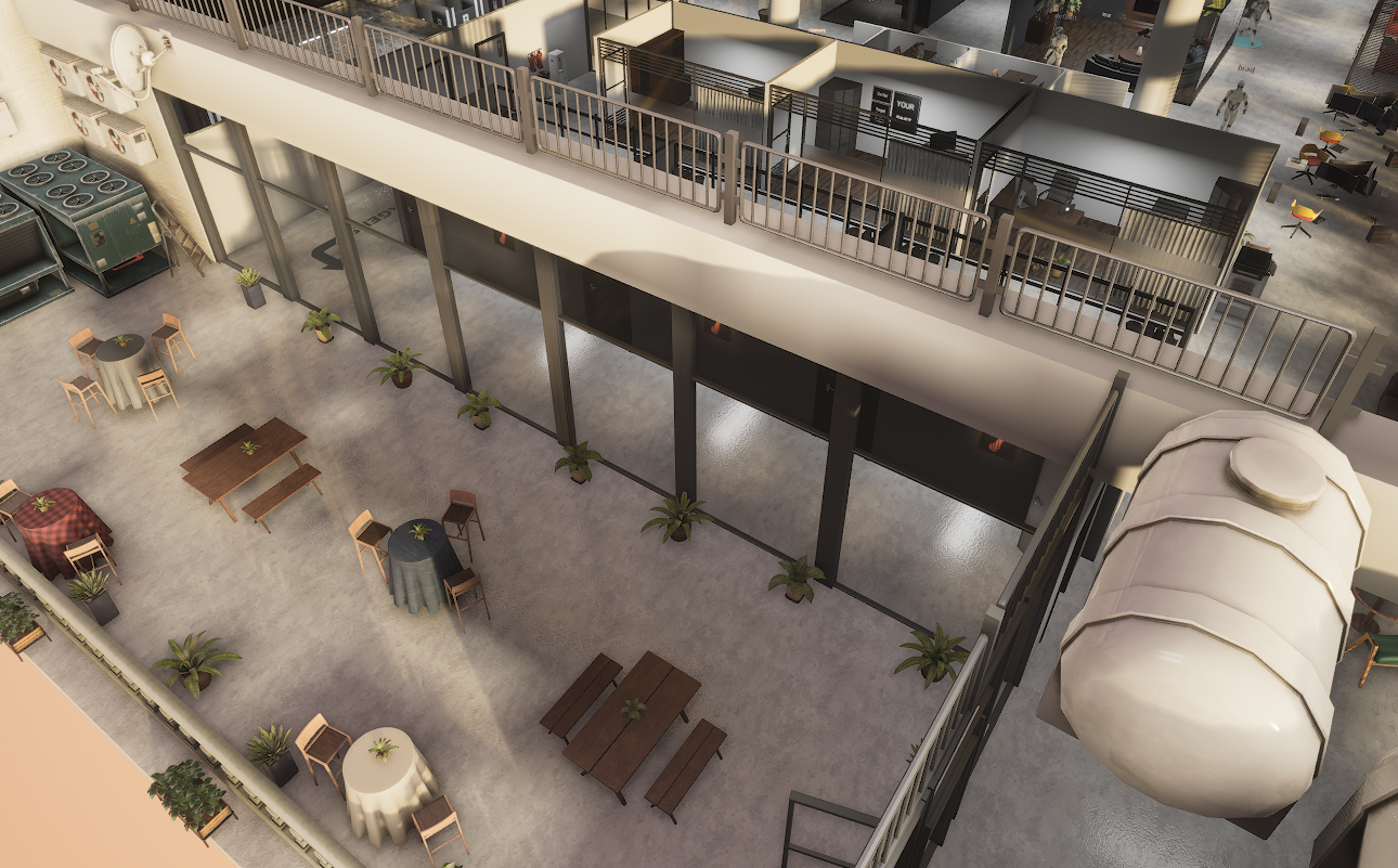 Open dining courtyard with picnic tables, plants and a mezzanine balcony above